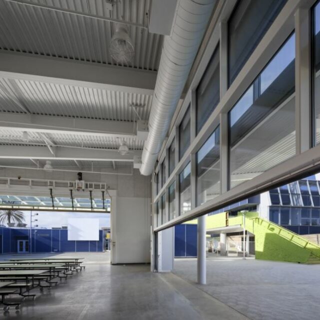 Interior of the Gallo Center for the Arts auditorium with multiple levels of red seating, curved balconies, and a central stage view.
