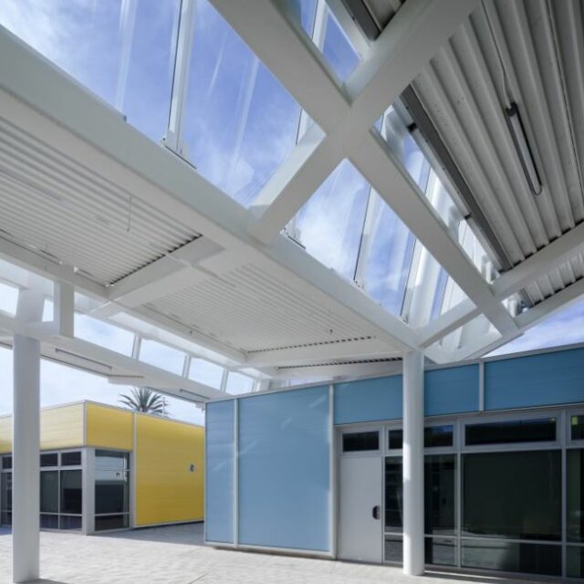 Exterior view of Hoag Hospital in California at sunset, showing modern glass façade and high-rise architecture.