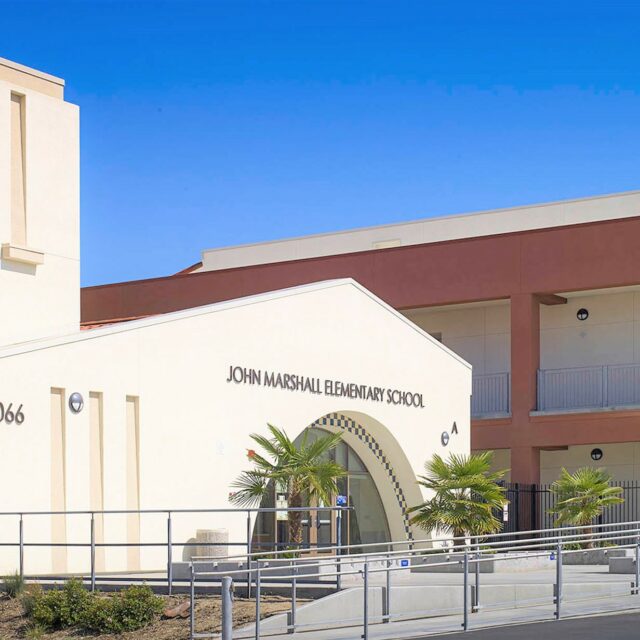 Two-story elementary school building with accessible entry and courtyard