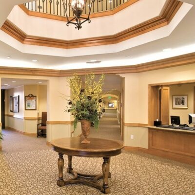 Reception area of senior health center with wood accents and round table