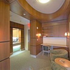 Hospital lounge area with wood-paneled walls and desk space