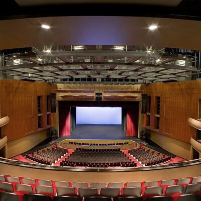 Interior of Renee and Henry Segerstrom Concert Hall showing tiered balconies, wood finishes, and advanced acoustic ceiling panels.