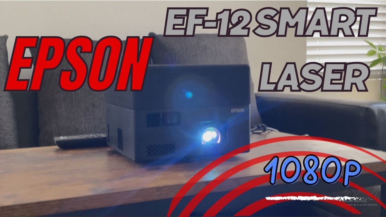 Epson EF-12 smart laser projector review thumbnail showing compact black projector on table with lens light on, bold text ‘Epson EF-12 Smart Laser 1080p