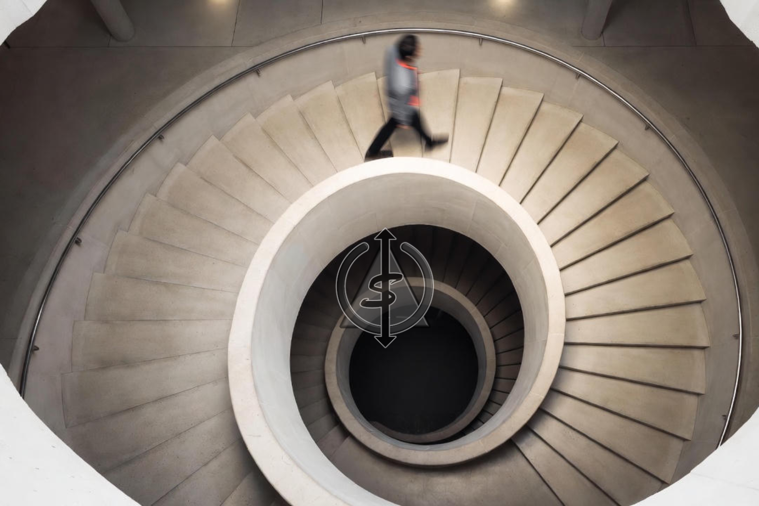Person climbing a spiral staircase seen from above, showing the same circular path rising higher with each step to symbolize quiet upward growth.