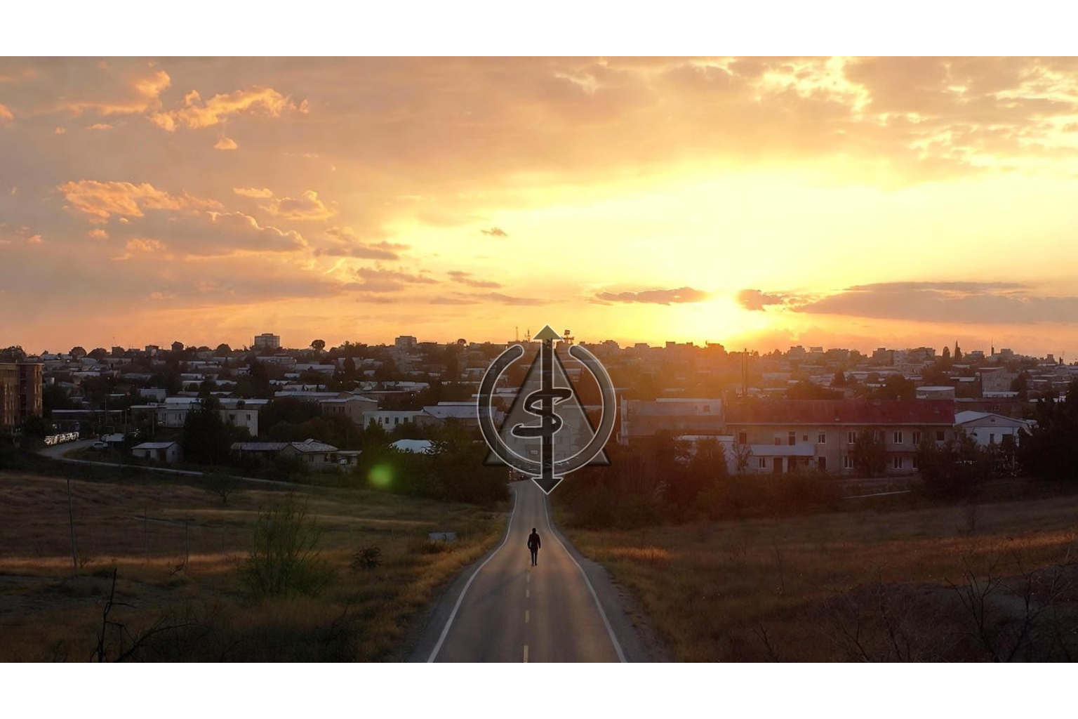 Person walking along a winding road away from a dim town toward warm light on the horizon, symbolizing leaving an old life behind to step into a new one.
