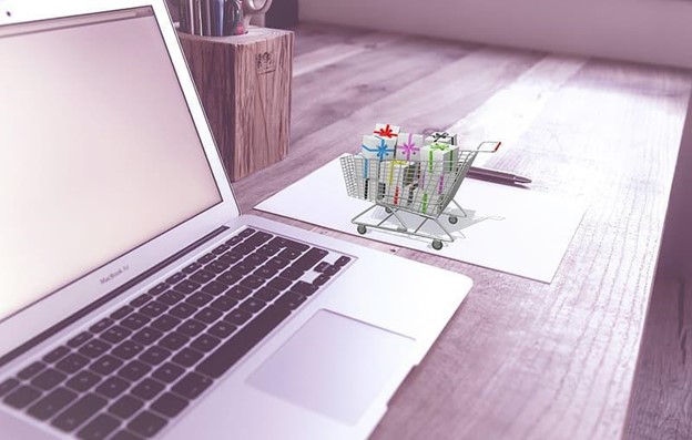 Laptop on a Desk with a Mini eCommerce Shopping Cart