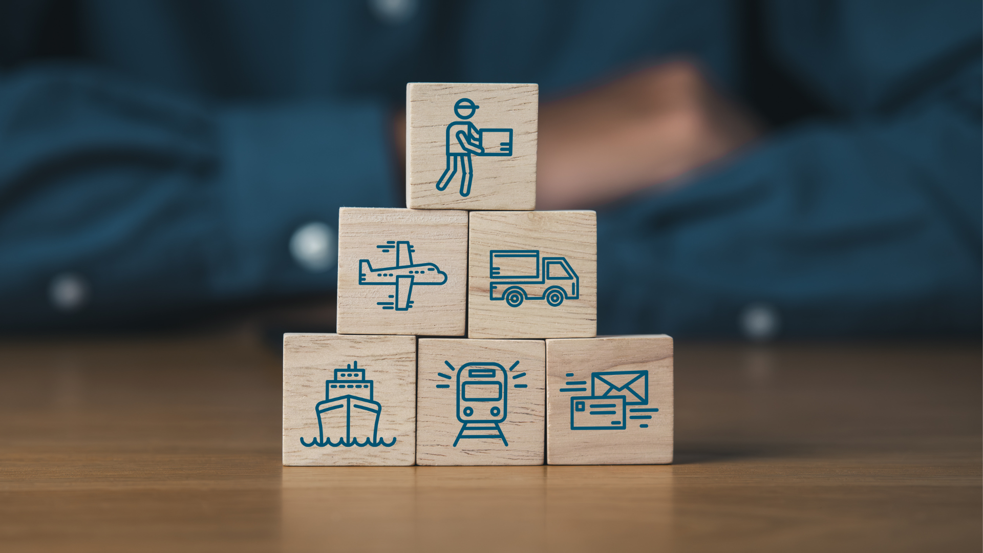 Pyramid of building blocks representing supply chain stages, with icons for transport, logistics and freight