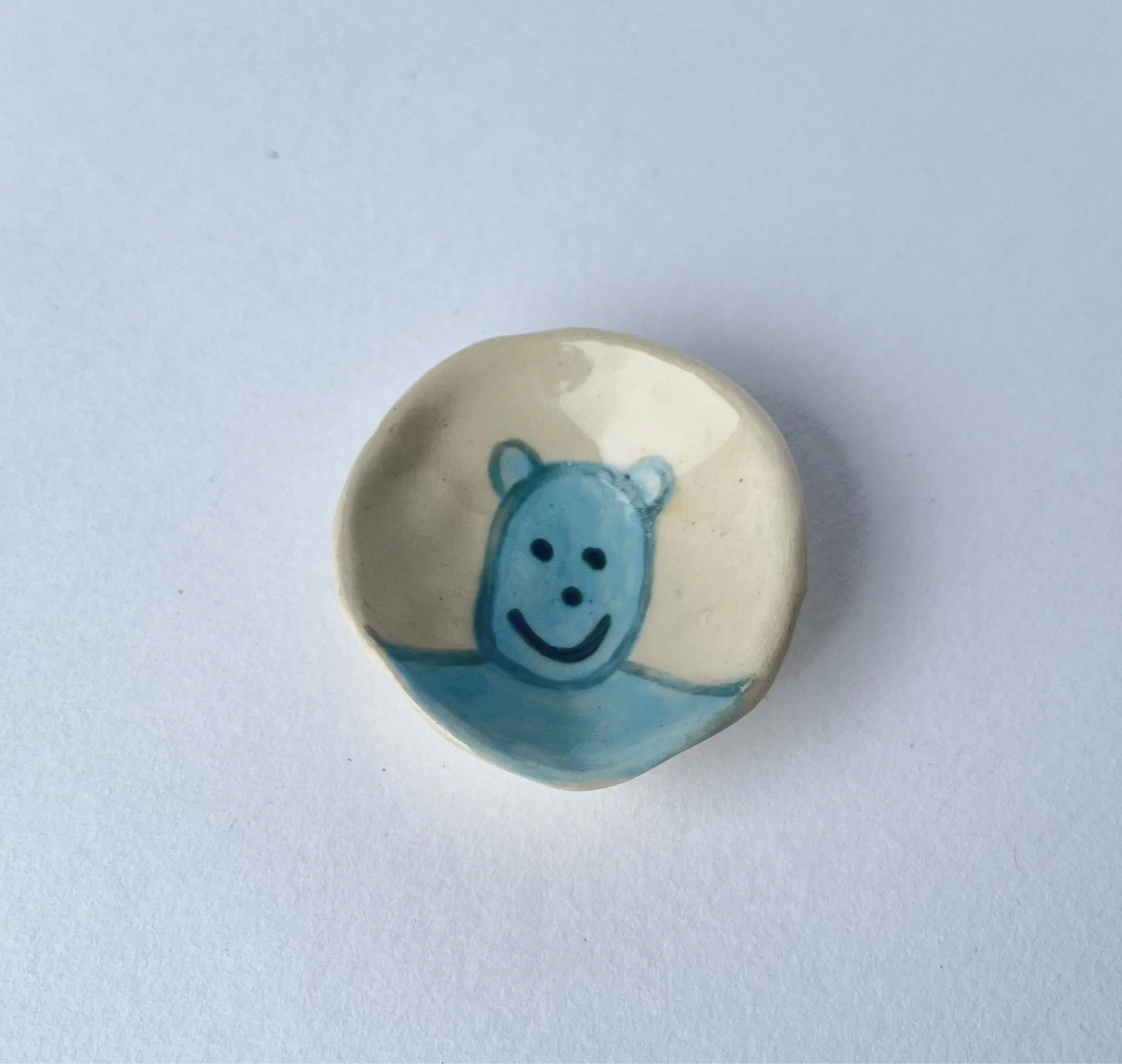 small ash tray with a cute blue character named borky.