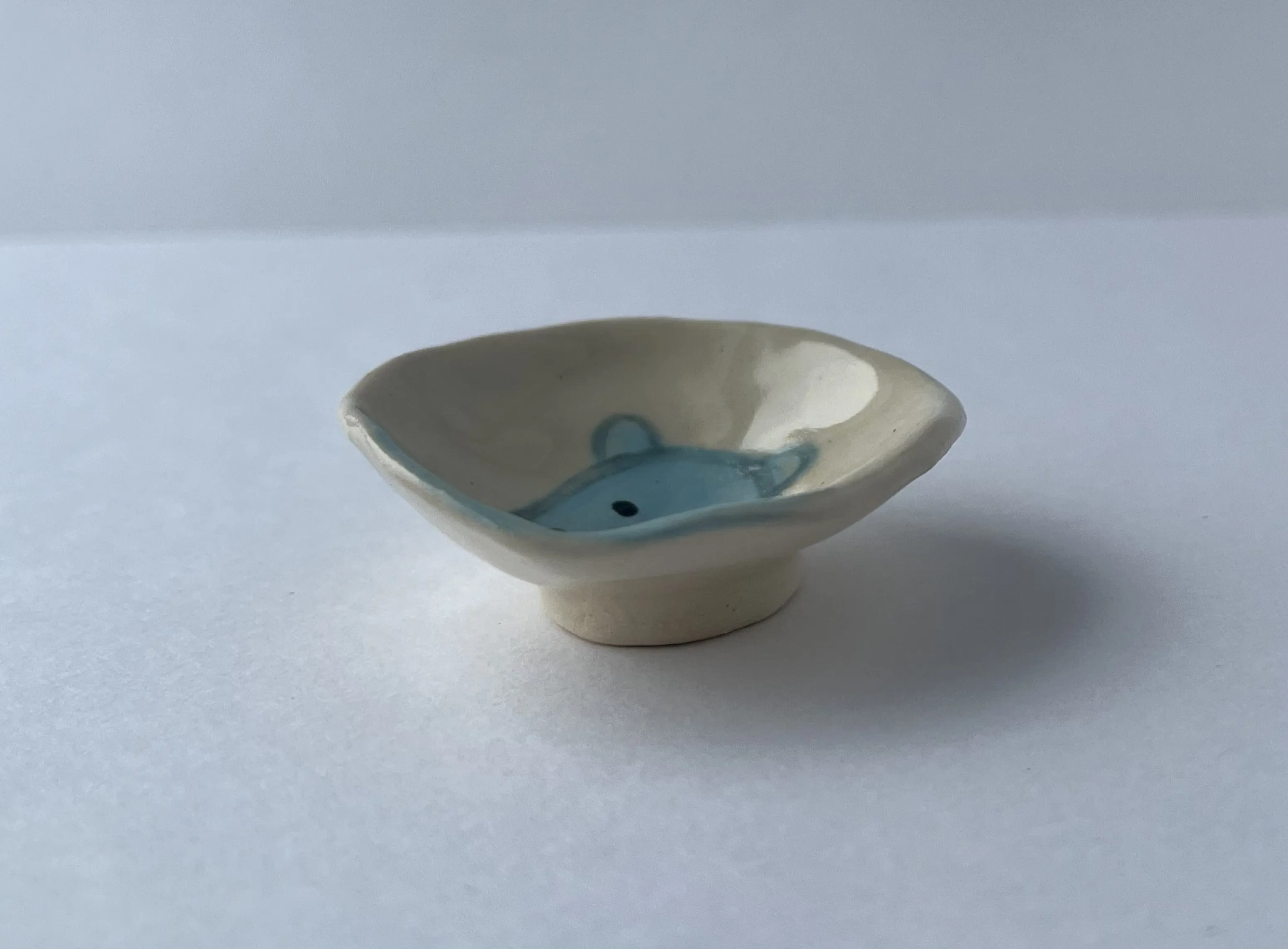 small ash tray with a cute blue character named borky.