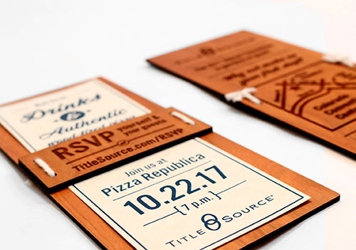 Wooden engraved invitation from an angle
