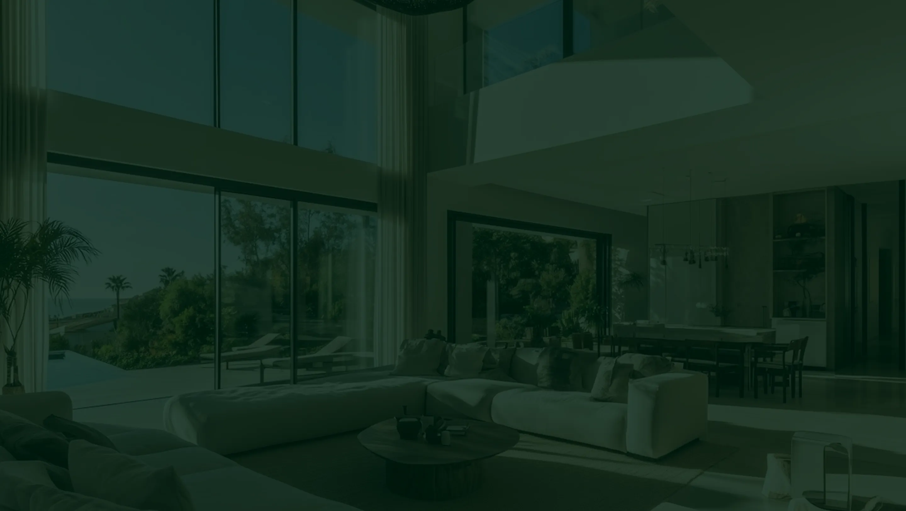 Modern living room with large windows overlooking tropical garden landscape