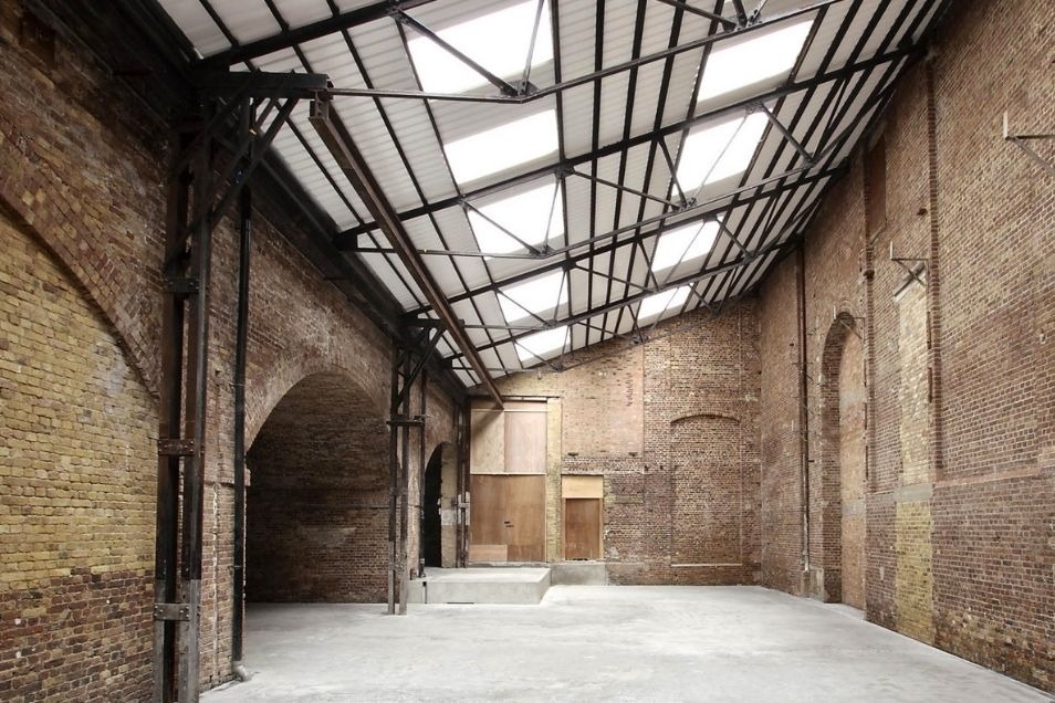 Industrial brick interior with glass ceiling and metal framework