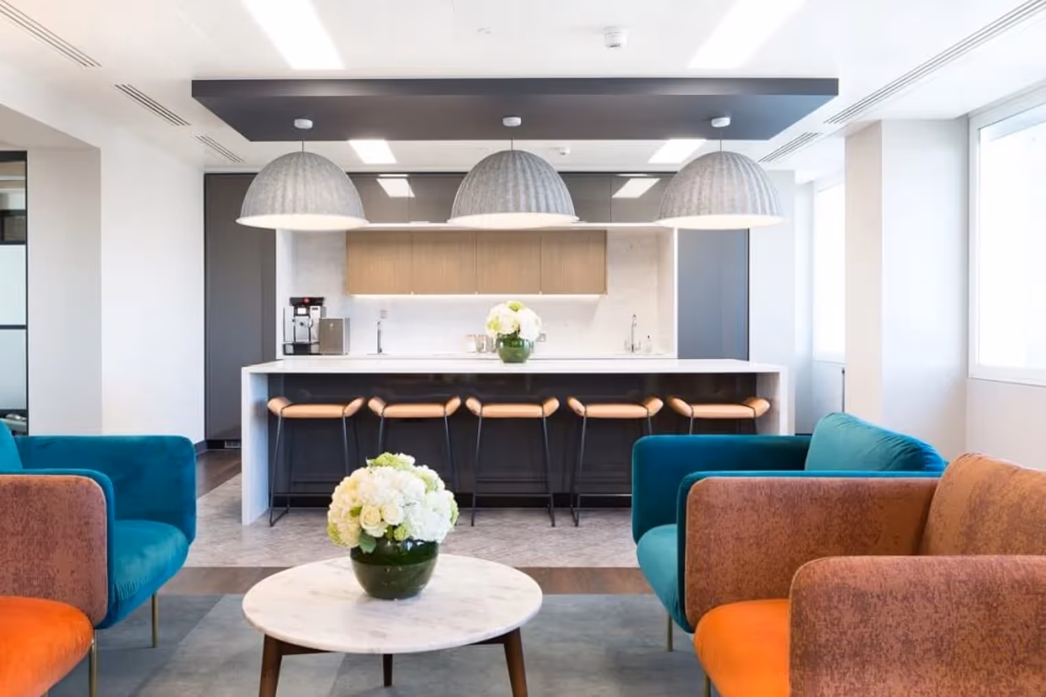 Landmark - Cavendish Square kitchen and lounge space. Blue and Orange big, block chairs.