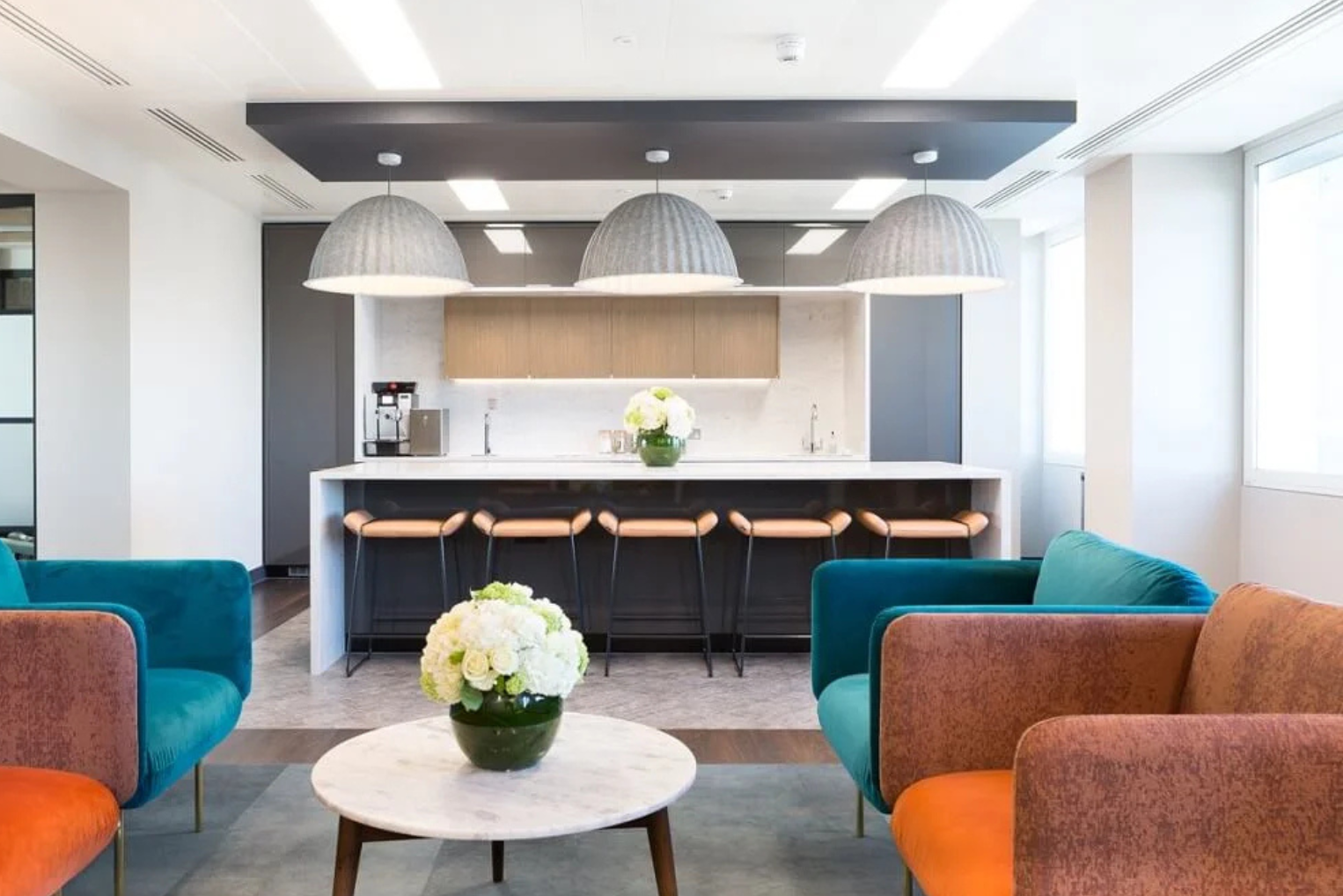 Landmark - Cavendish Square kitchen and lounge space. Blue and Orange big, block chairs.