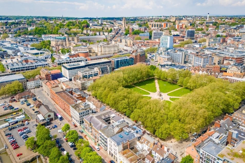 Bird's-eye view of Bristol City Centre featuring a large green square, surrounded by urban architecture and trees.