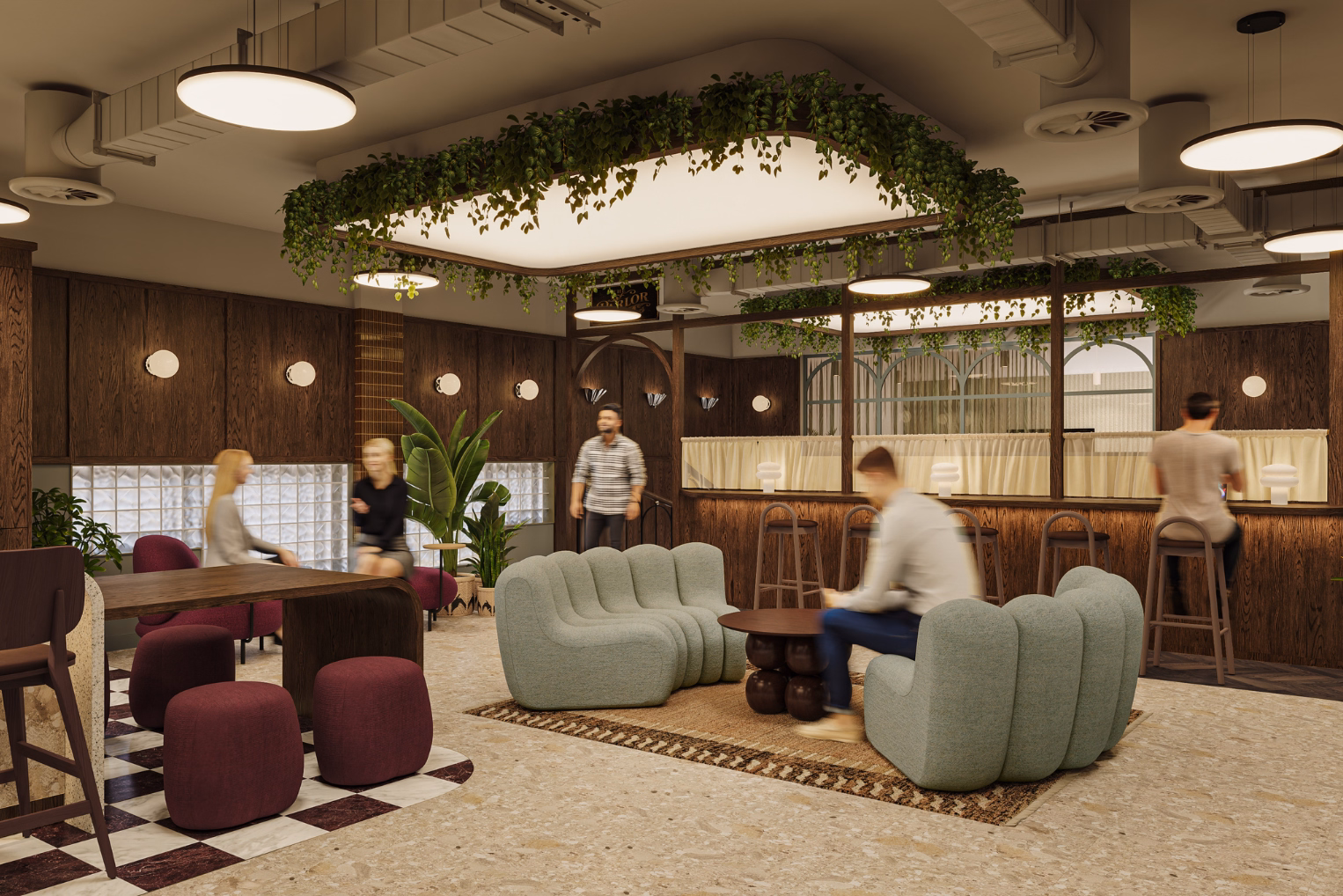 office lounge with green ribbed sofas, plum ottomans, and dark wood walls. Large overhead lights with hanging plants illuminate the social workspace.
