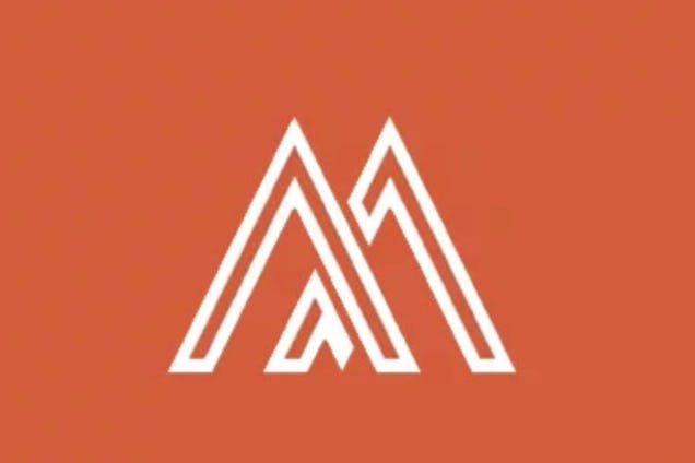 A minimalist white logo of two interlocking, peaked mountain-like lines centred on a solid rust-orange background.