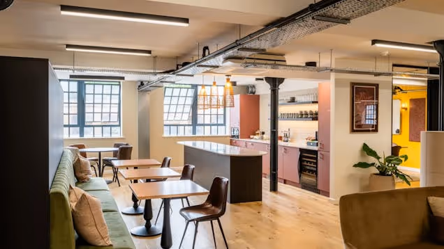 A breakout space and tea point image, with soft furnishing and cafe style tables.