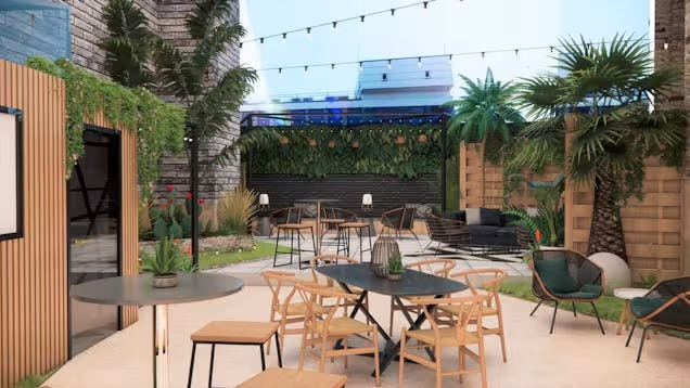 Outdoor terrace with tables, chairs and greenery under string lights, creating a relaxed social space.