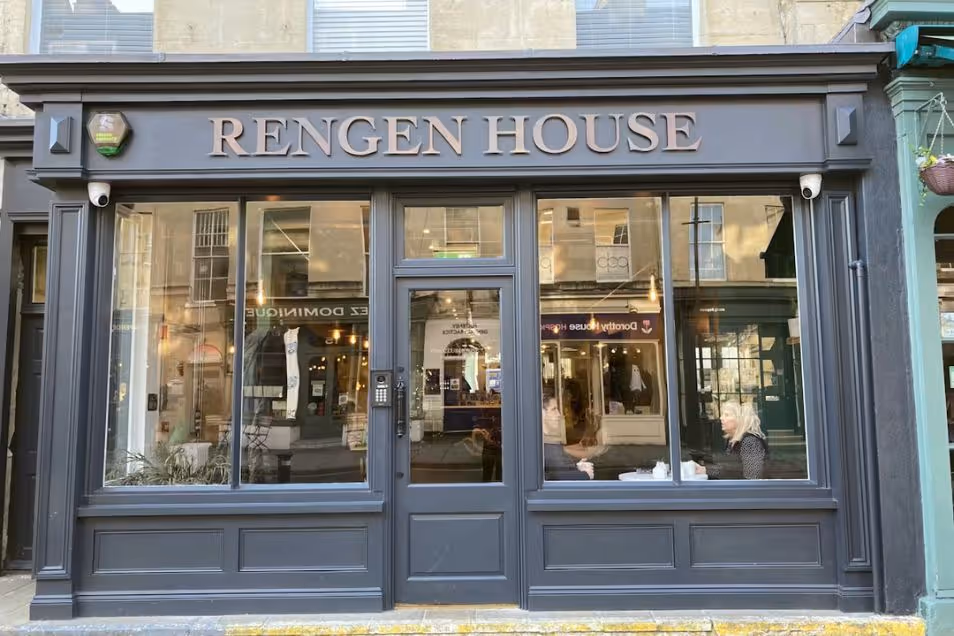 Storefront for "Rengen House" featuring a dark charcoal wood facade, large glass display windows, and gold lettering on the signage.