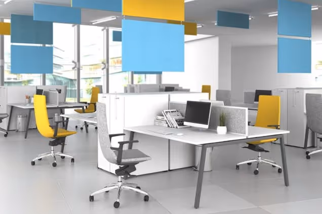 Yellow and grey chairs at white desks in an office with blue and yellow panels hanging from the ceiling.