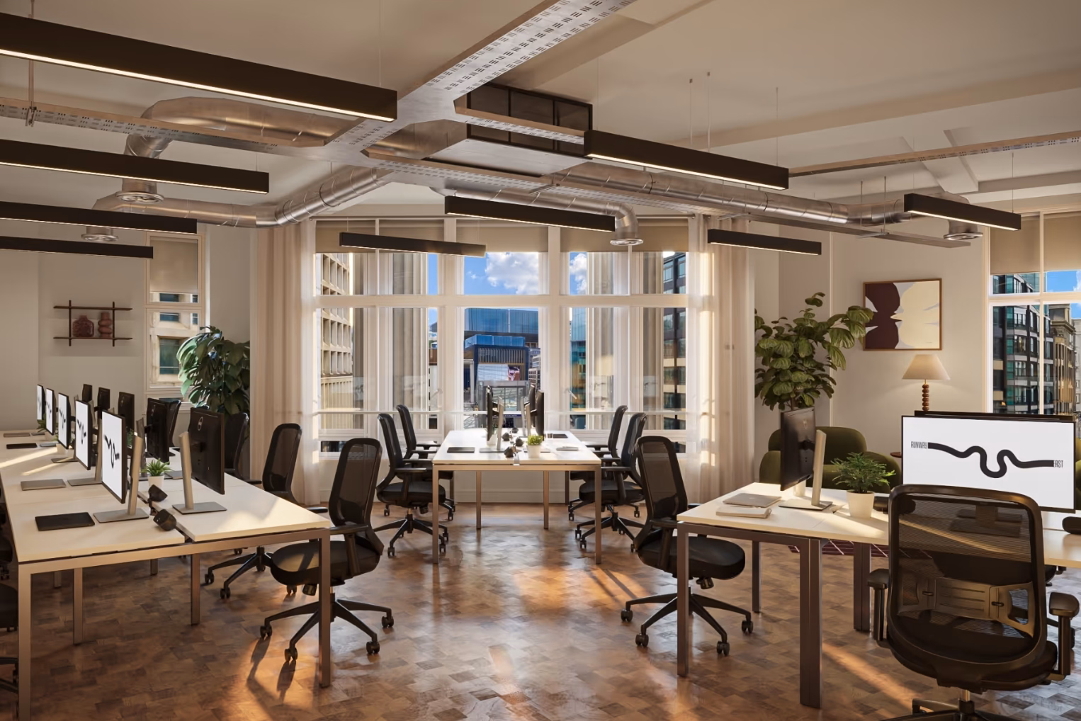 Black chairs sit at white desks on a wood floor under silver pipes and black lights near windows.