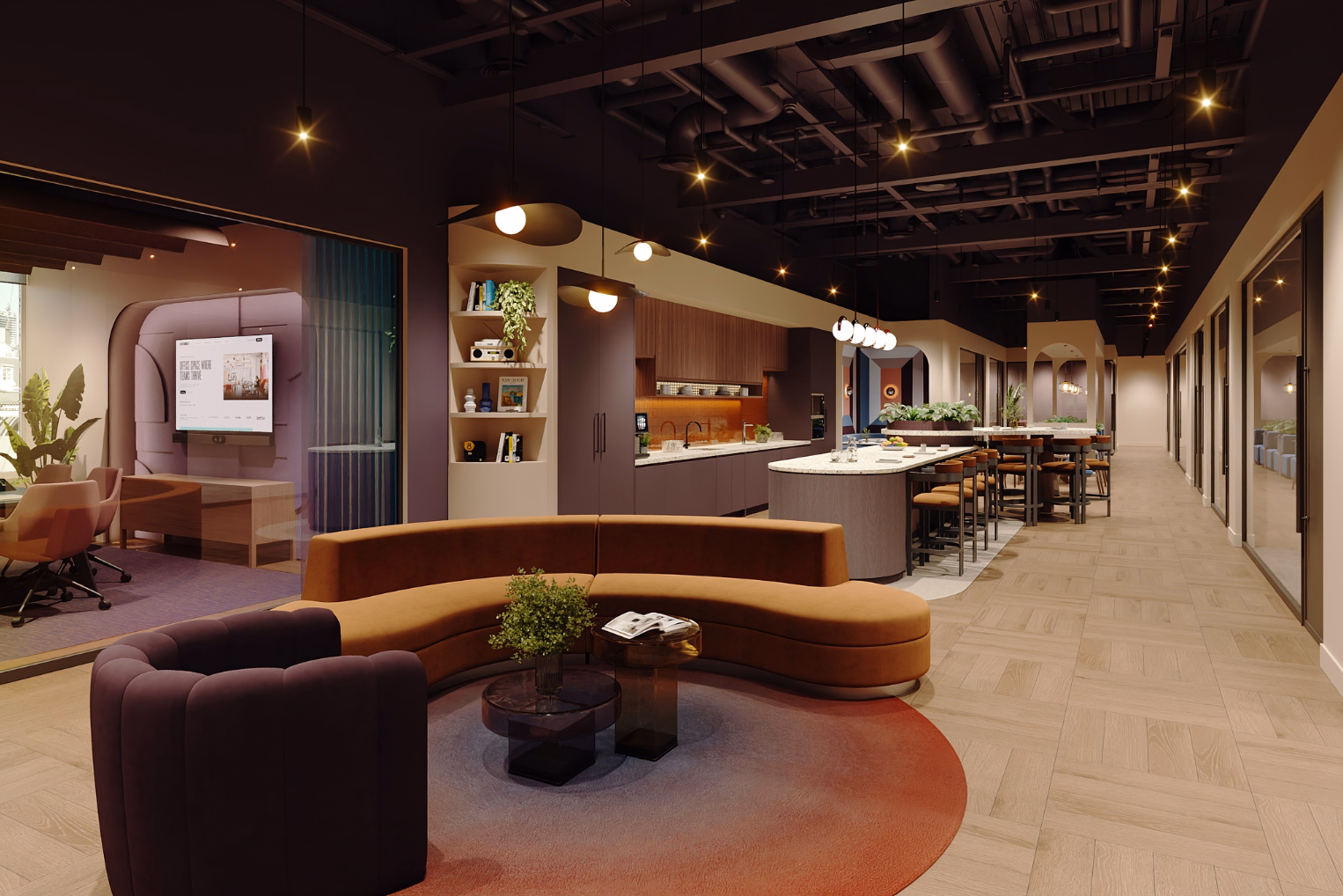 An office lounge with a purple armchair and orange curved sofa on a round rug, next to a kitchen with a grey island and brown bar stools.