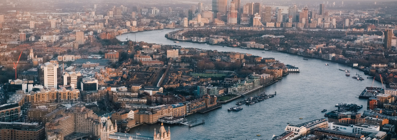 An aerial view of the River Thames and surrounding buildings.