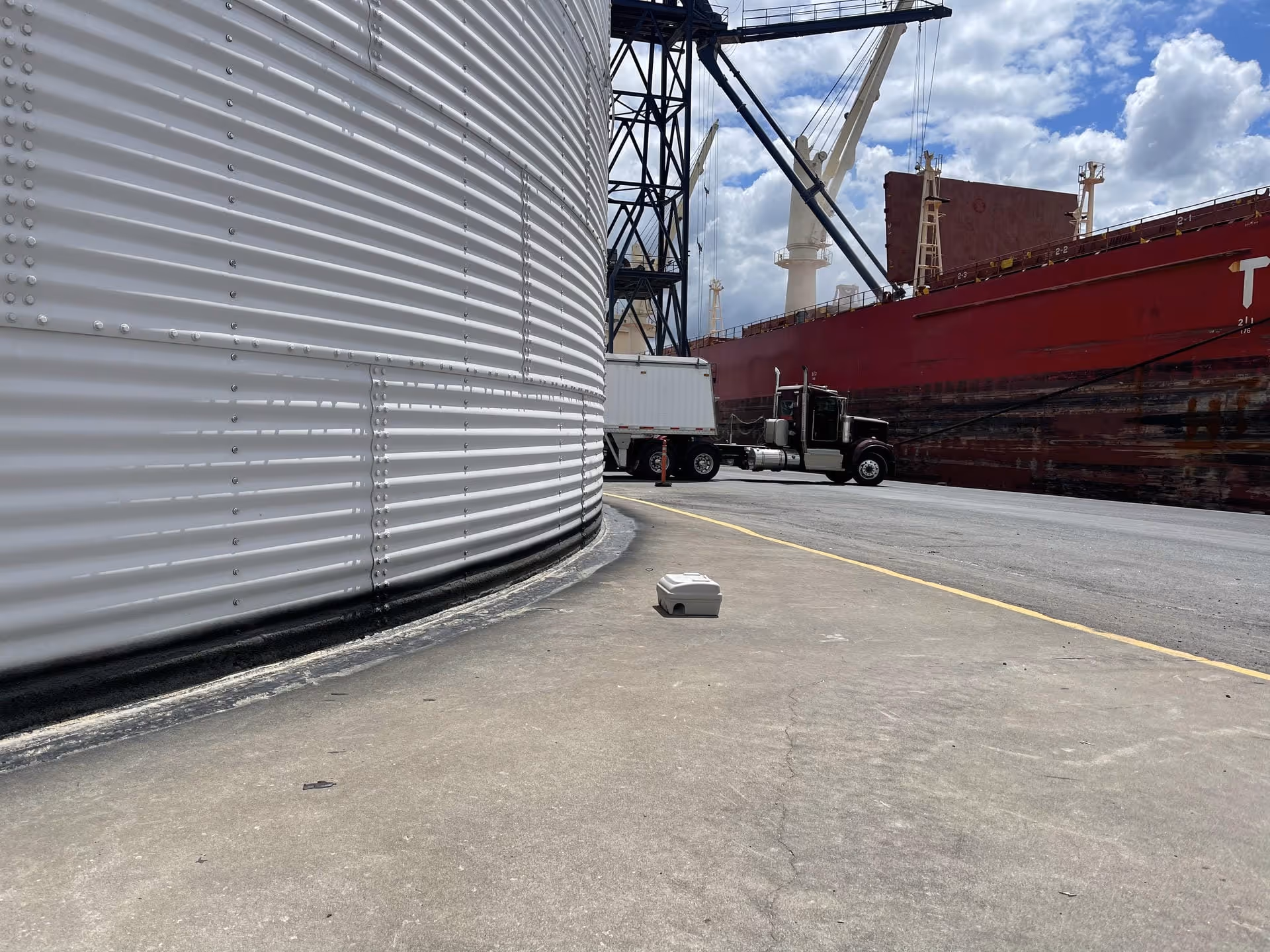 Industrial grain bin base waterproofing membrane application at Richardson Port Terminal in Hamilton, Ontario.