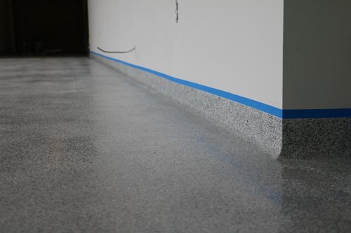 Easy-clean epoxy flake flooring with rolled radius cove in a Sarnia, Ontario school.