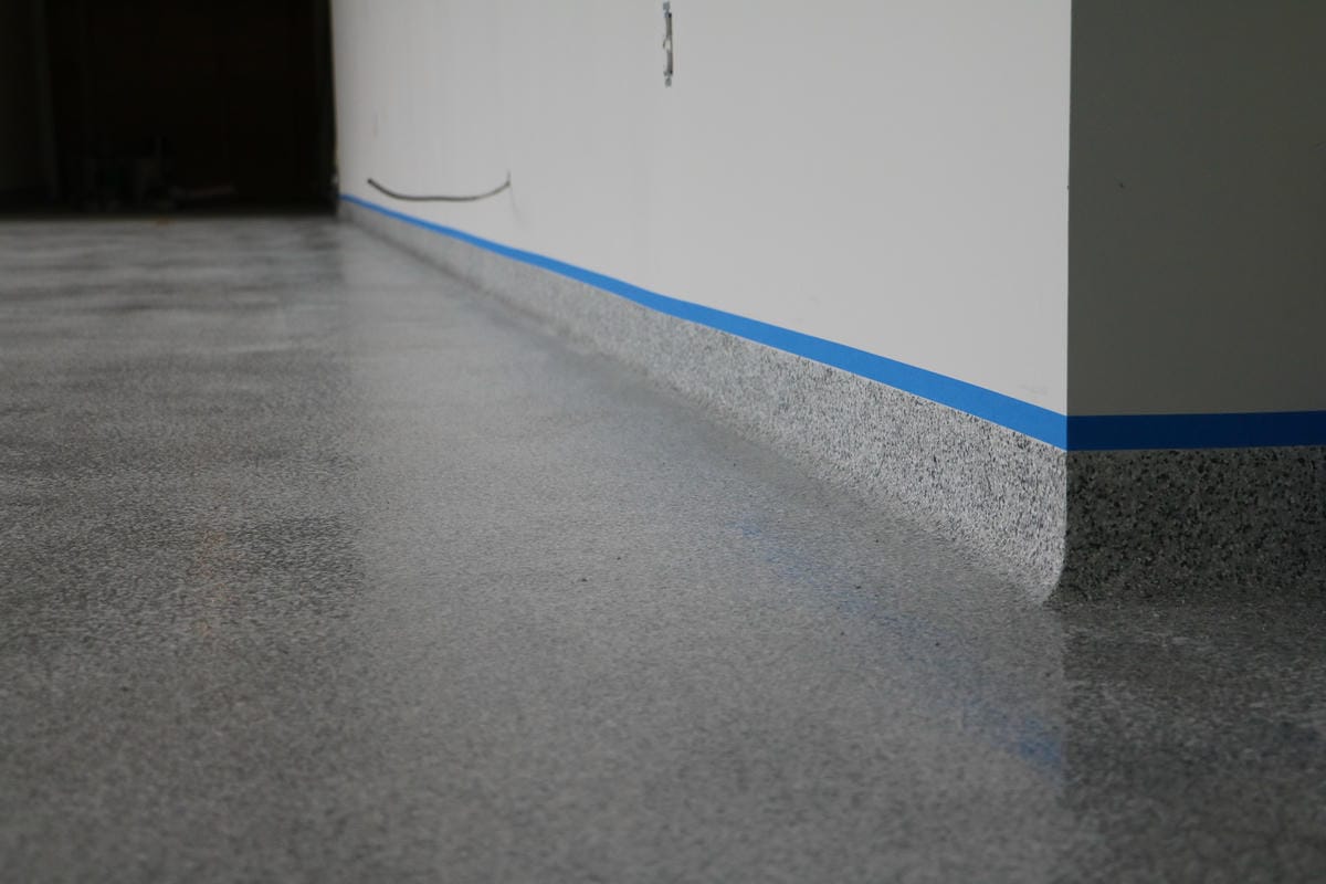 Easy-clean epoxy flake flooring with rolled radius cove in a Sarnia, Ontario school.