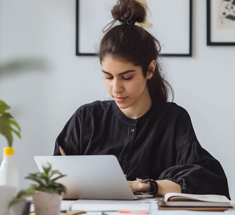 Young woman working on laptop in home office