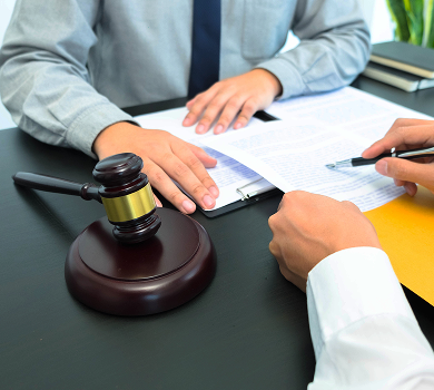 Judge's gavel beside professionals signing trademark documents – How to file a trademark in Spain