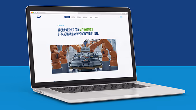 Laptop showing a webpage about automation of machines and production lines with an image of robotic arms on an assembly line.