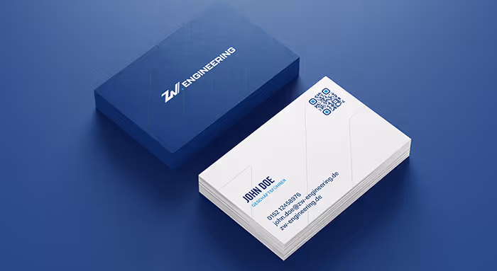 Stack of white business cards with blue text and a QR code, next to a dark blue card box labeled ZW Engineering.