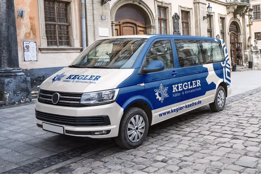 White and blue company van parked on cobblestone street, branded with Kegler Kälte- & Klimatechnik logo and website.