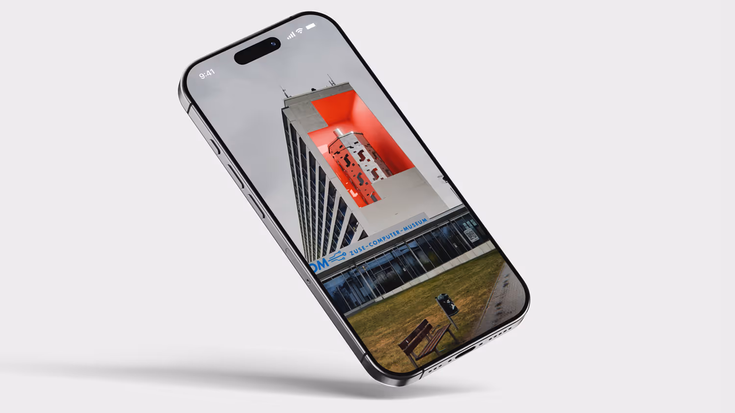 iPhone 16 mockup displaying a building with a red geometric structure and the text ZUSE COMPUTER MUSEUM on the facade.