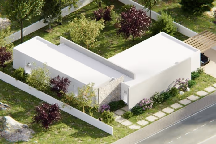 Aerial view of a modern single-story white house with flat roofs, surrounded by a white fence and landscaped garden with trees and shrubs.