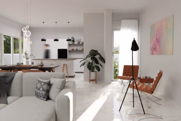 Modern living room with gray sofa, tan leather chairs, floor lamp, and large plant near a bright window.