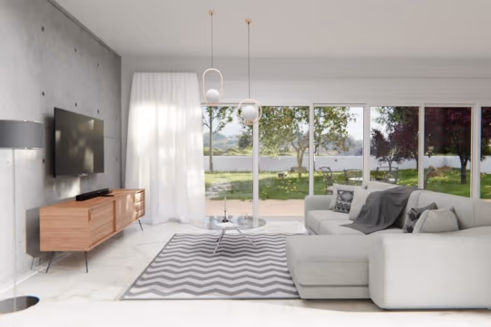 Modern living room with a large white sectional sofa, chevron-patterned rug, wooden TV console, and floor-to-ceiling windows overlooking a green garden.