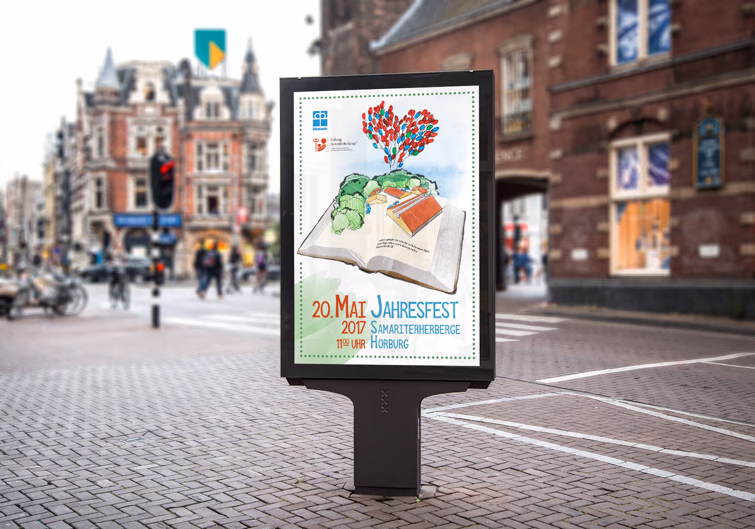 Street billboard showing an illustrated open book with trees and balloons forming a heart, advertising the 2017 annual festival at Samariterherberge Horburg on May 20 at 11:00 AM.
