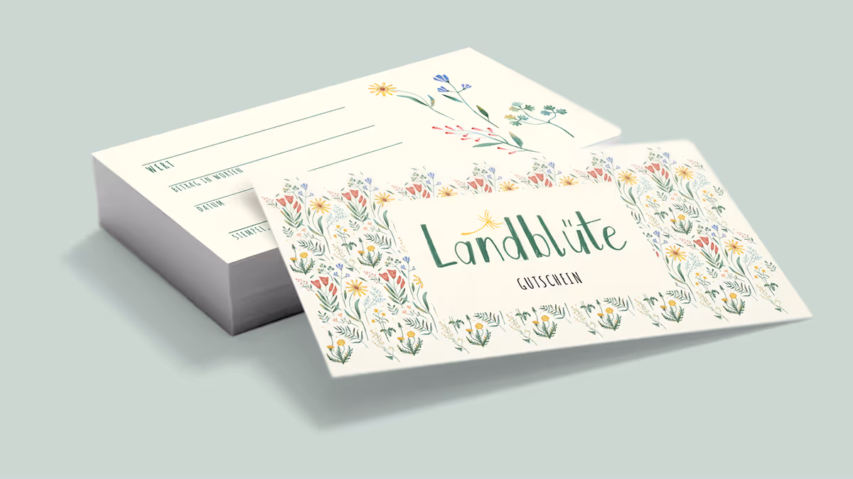 Gift certificate with floral border and the text 'Landblüte Gutschein' on a pale green background.