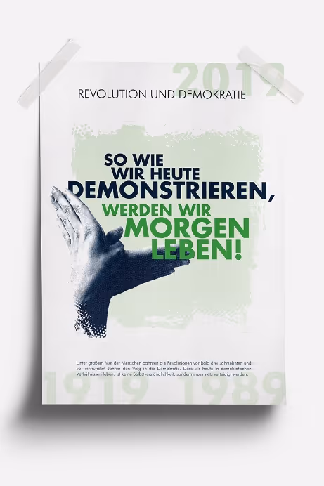 Poster with text about revolution and democracy, showing two hands clapping and a message in German about demonstrating today to live tomorrow.