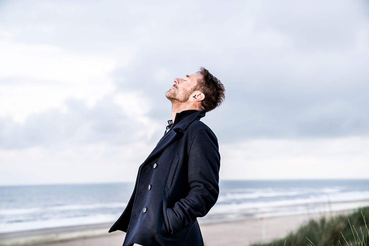 Man taking deep breath on beach