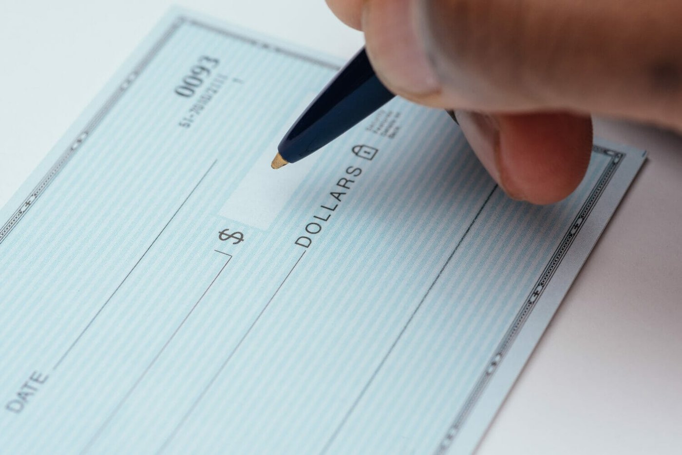 An immigrant writes a check