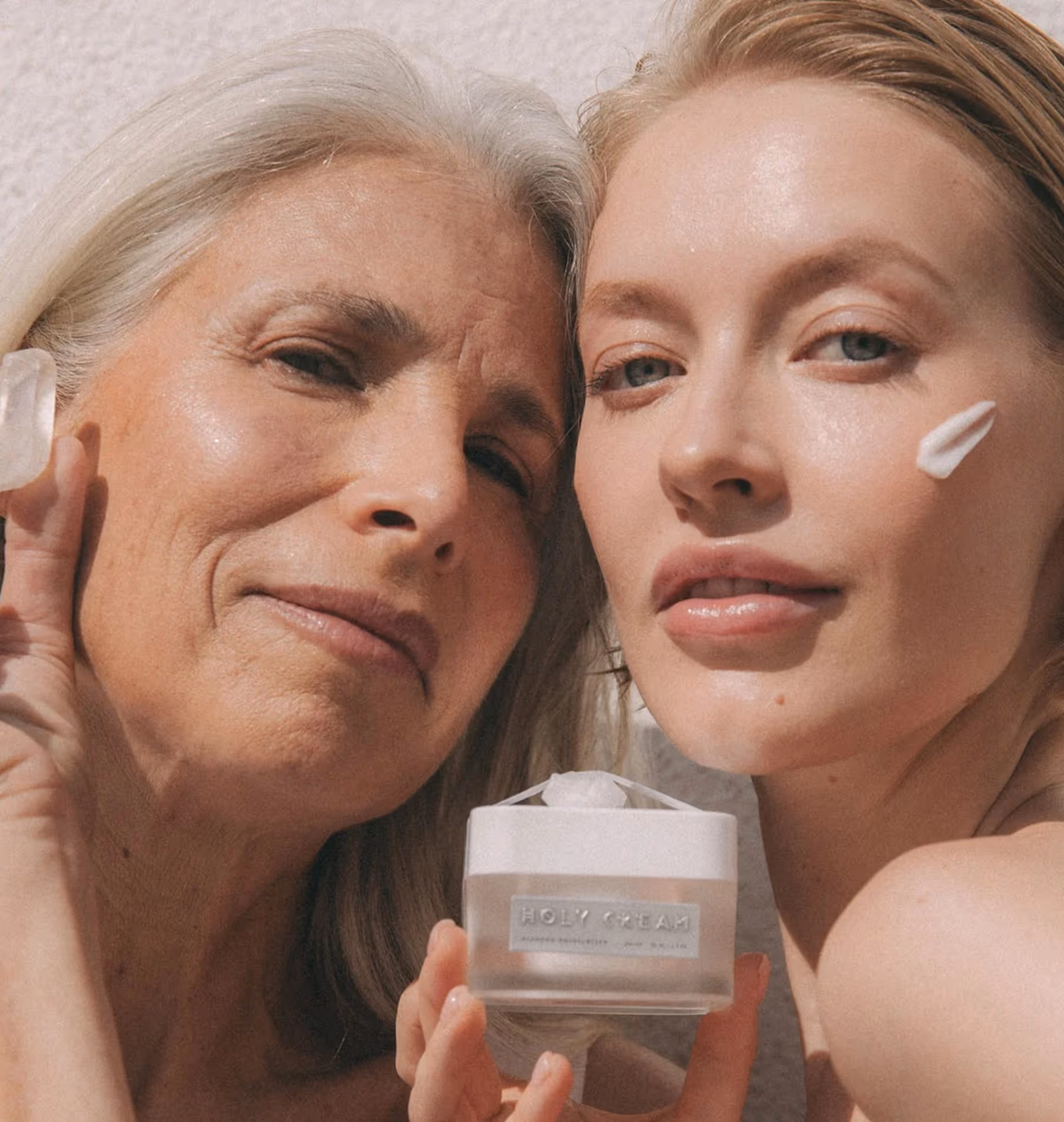 two women holding a jar of cream