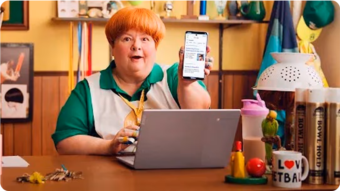a woman holding a phone and smiling