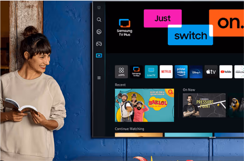 a woman standing in front of a television screen