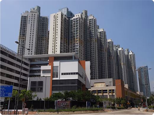 Hong Kong public housing estate with tall residential towers and community facilities, representing the type of neighborhood where UNC provides services to ethnic minority families