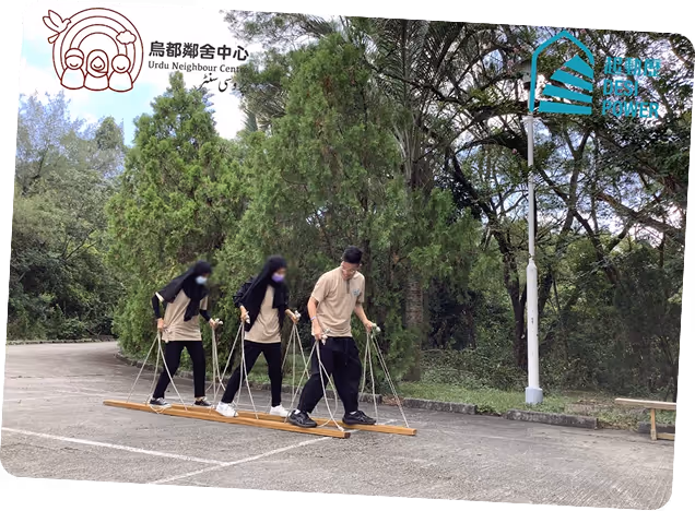 Three participants using mobility canes practicing navigation skills on an outdoor path surrounded by trees, part of UNC's accessibility training program for visually impaired individuals